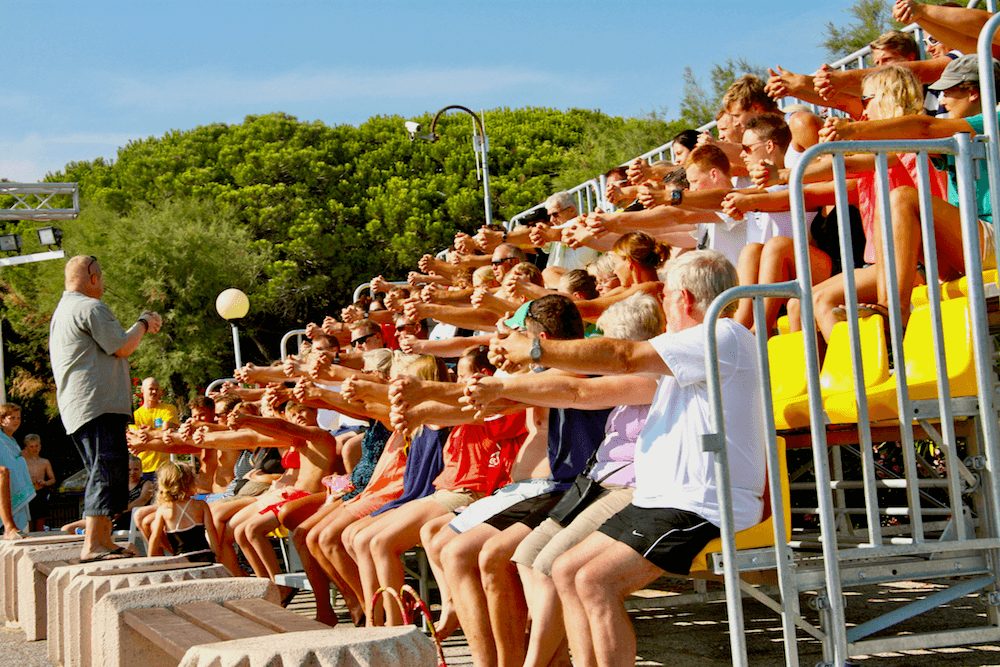 Audience members reacting during a Martin Castor stage hypnosis show